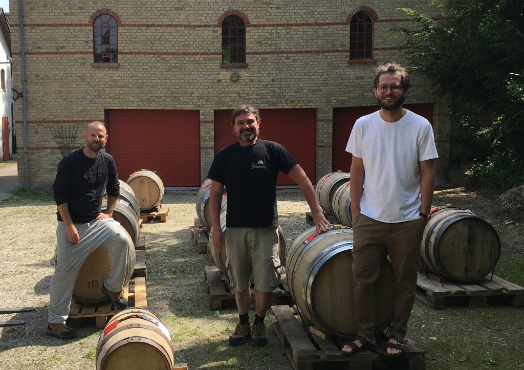 Terkel Kleist, Kristian Kram and Henrik Hammer with Reinheart casks outside the mill at Vintre Møller.